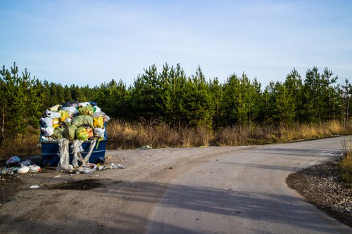 Operatives loading a van with secured bulky waste for disposal